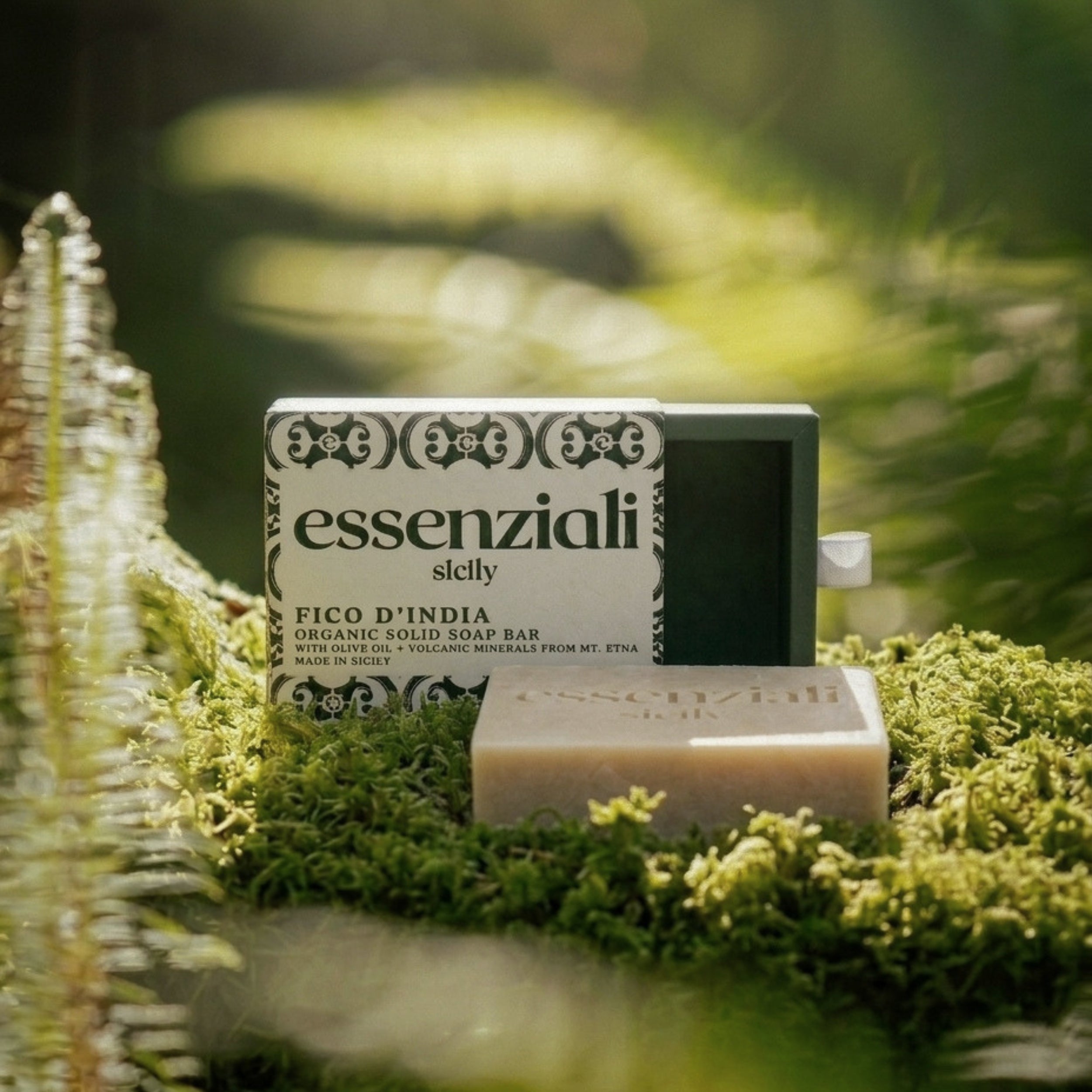 essenziali soap bar with packaging on a grassy background