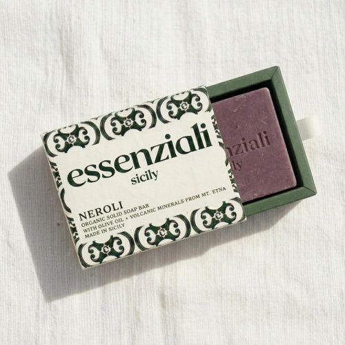 Purple soap bar in a green box with 'essenziali sicily' packaging on a white background