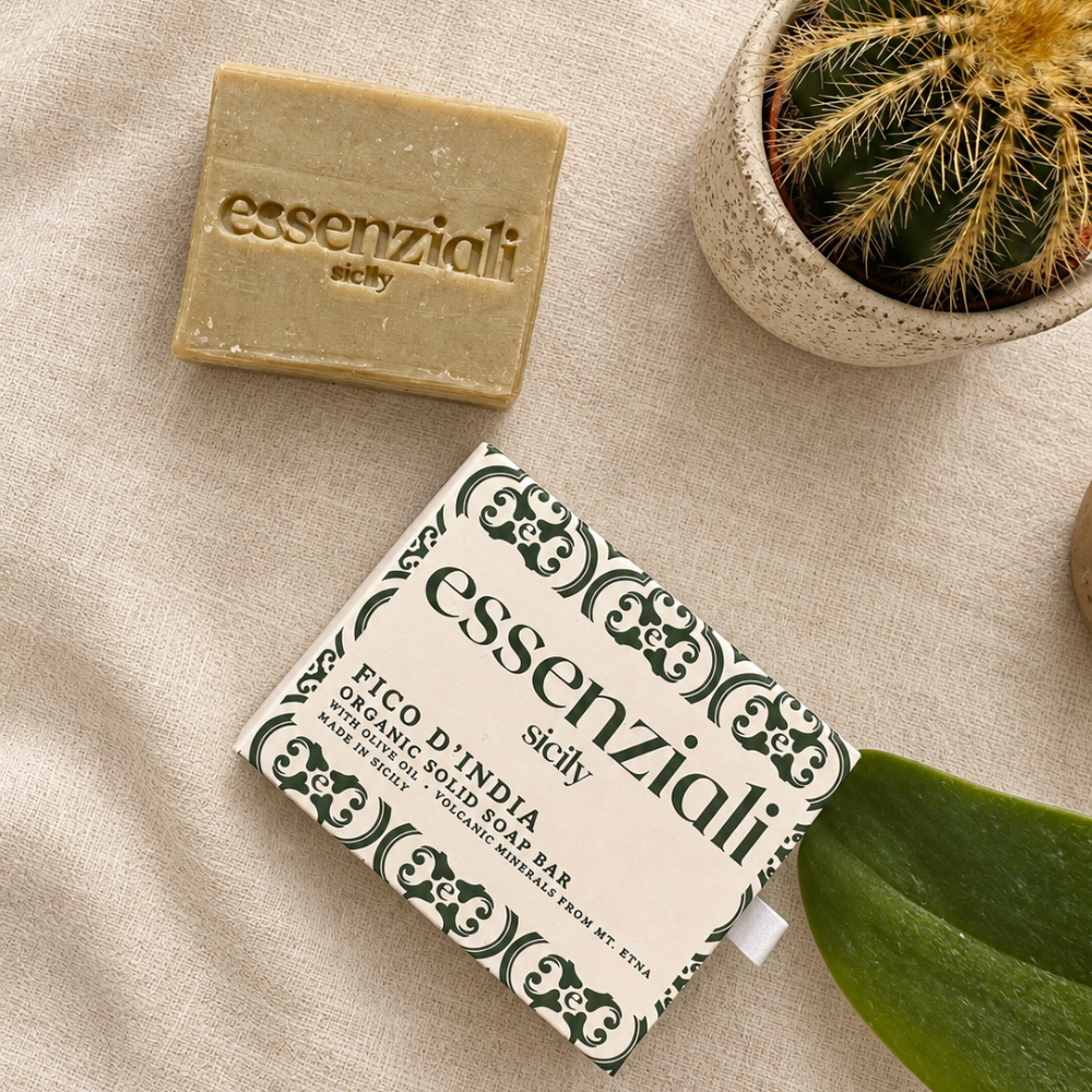 Flat lay of Essenziali Fico d'India soap, patterned packaging and a cactus on pale linen